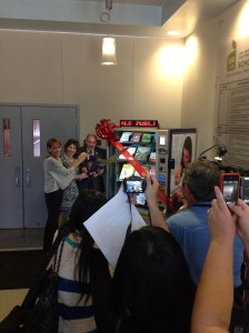 Mayor Spitaleri and Director Rosenblum cut the ribbon on the new Library Lending Machine
